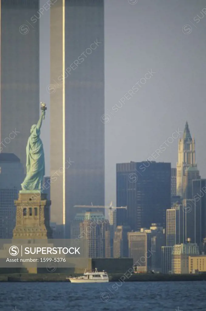 Statue of Liberty with the World Trade Center Buildings at Sunset, New York City , New York