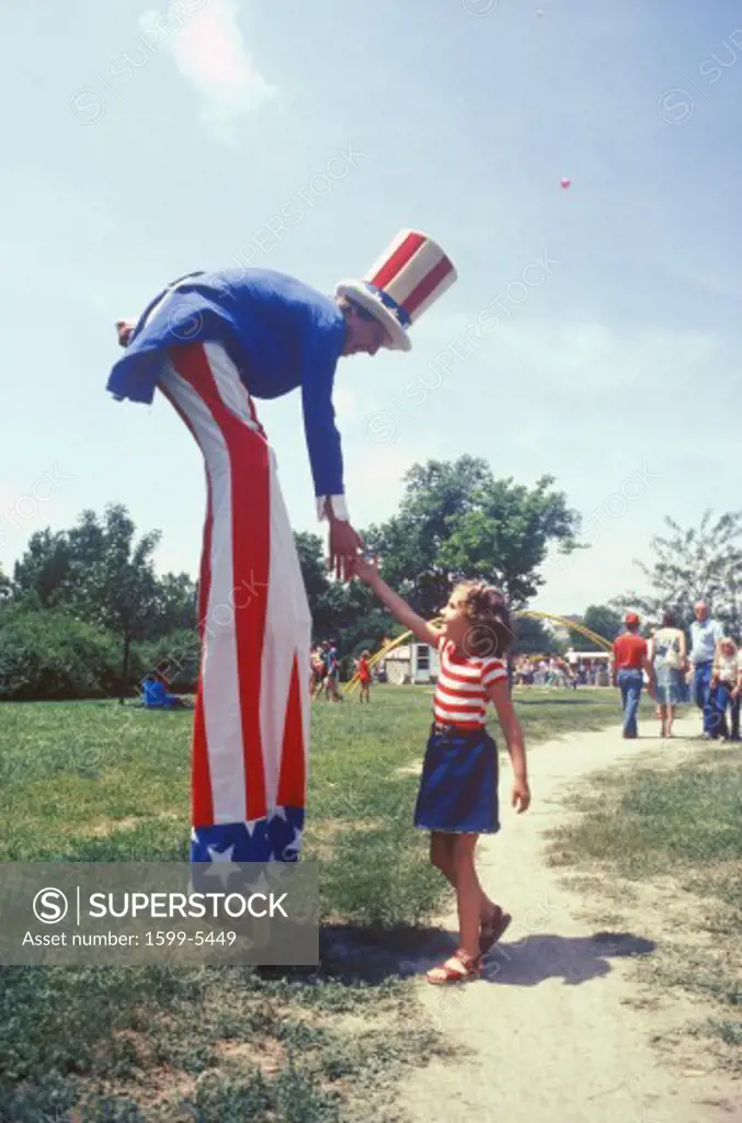Uncle Sam on stilts Shaking Girl's Hand, Salina, Kansas