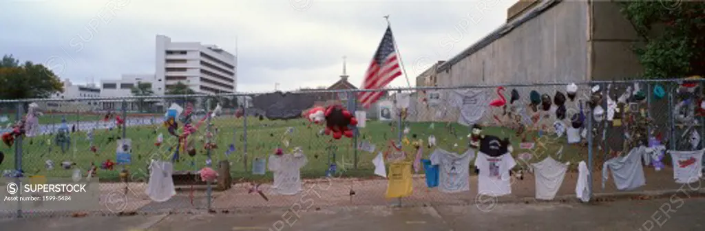 Temporary Memorial for 1995 Oklahoma City Bombing with flags, pictures and personal notes on fence