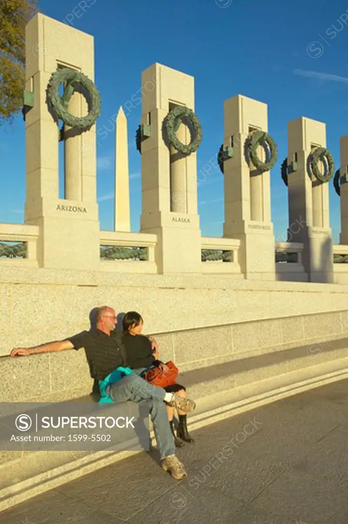 A couple sitting at the U.S. World War II Memorial commemorating World War II, Washington D.C.