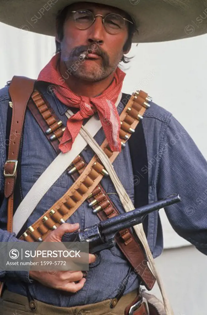 Portrait of Old West gunslinger participant with pistols, CA