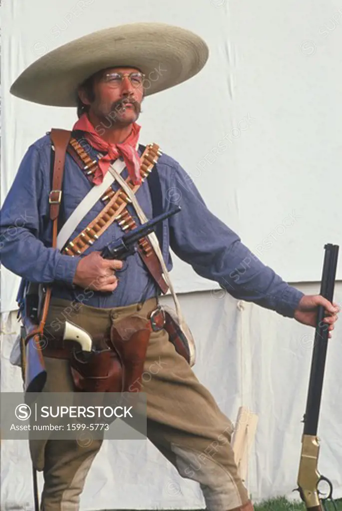 Portrait of Old West gunslinger participant with pistols, CA