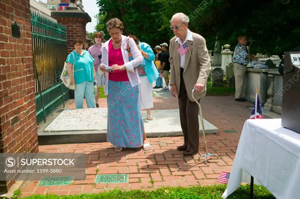 Two seniors look at Ben Franklin's cemetery stone in Christ Church Burial Ground Philadelphia, Pennsylvania