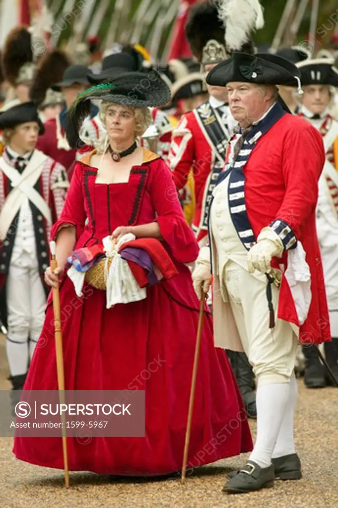 British officer and lady in red dress watch with disdain the British surrender to General George Washington at the 225th Anniversary of the Victory at Yorktown, a reenactment of the siege of Yorktown, where General George Washington commanded 17,600 American troops and French Comte de Rochambeau lead 5500 French troops, together defeating General Lord Cornwallis, who surrendered his arms on October 19, 1781, ending the Revolutionary War, thus making the 13 Colonies the United States of America, 