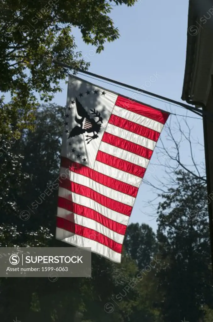 Early American flag is backlit in Yorktown, Colonial National Historical Park, Yorktown, Virginia