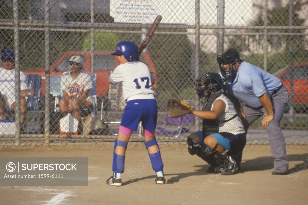 Girl preparing at bat with umpire, Girls Softball game, Brentwood, CA