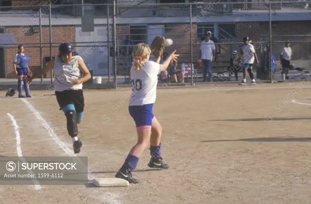 Girl running to base, striking out at Girls Softball game, Brentwood, CA