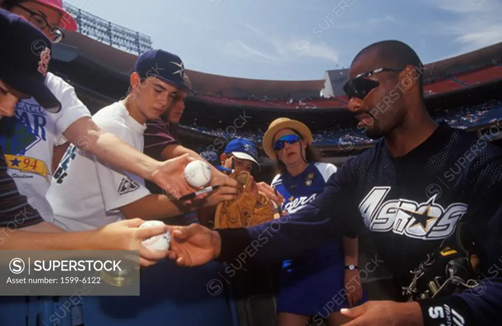 Professional Baseball player signing autographs and balls for young fans, Dodger Stadium, Los Angeles, CA