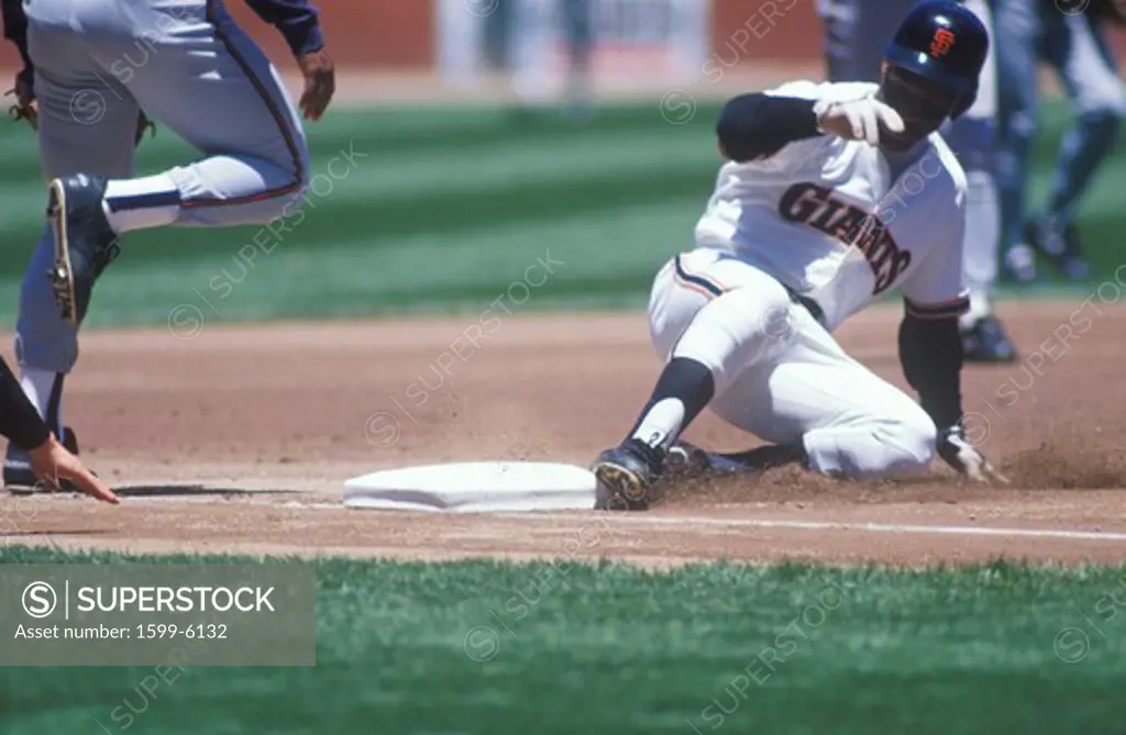 Professional Baseball player sliding into base during game, Candlestick Park, San Francisco, CA