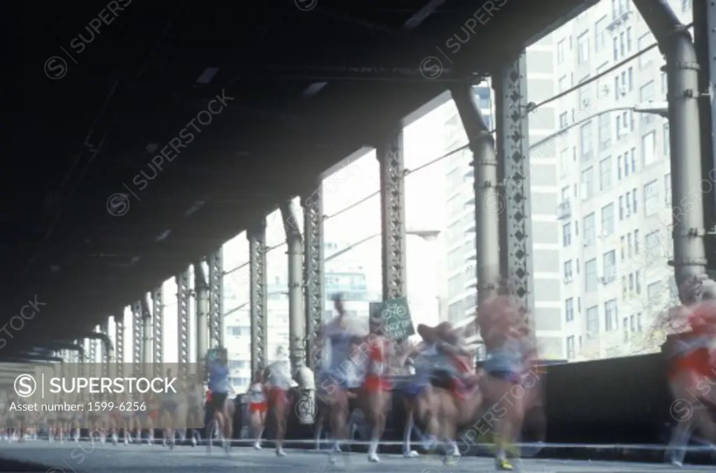 Runners crossing 1st Avenue/59th Street Bridge, NY City, NY Marathon