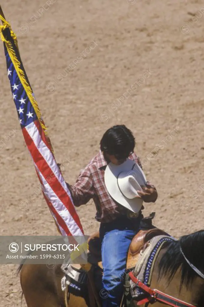 Native American with American Flag at opening ceremony of Inter-Tribal Indian Rodeo, Gallup, NM