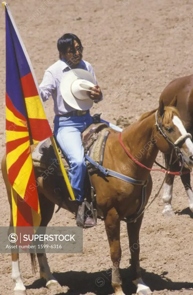 Native American on horseback at opening ceremonies at Inter-Tribal Indian rodeo