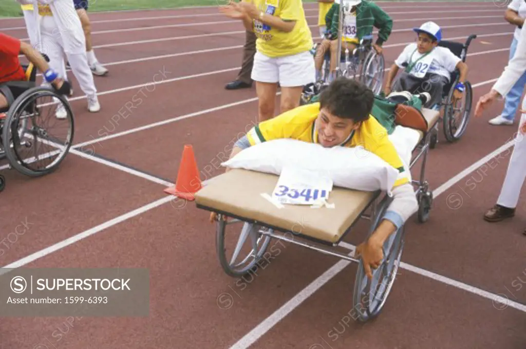 Special Olympics athlete on stretcher, competing in race, UCLA, CA