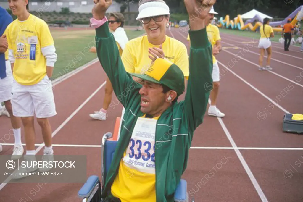 Handicapped Athlete cheering at finish line, Special Olympics, UCLA, CA