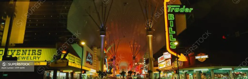 This is part of the strip in Las Vegas known as the Fremont Street Experience. There are neon lights lighting up the strip from the casinos at night.