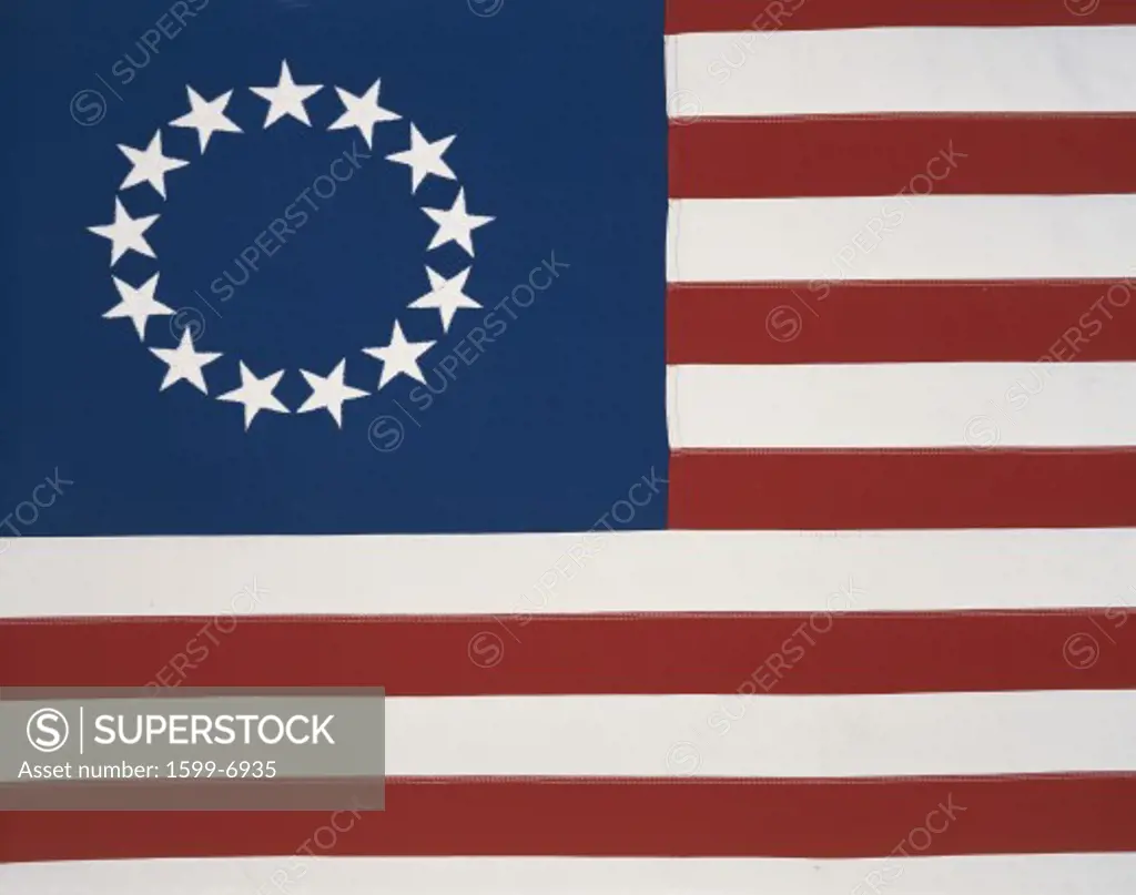 This is the original colonial flag with 13 stars representing the 13 original states at the time of the American Revolutionary War. The 13 stars are against a field of blue and the red and white stripes are sitting flat and move horizontally.