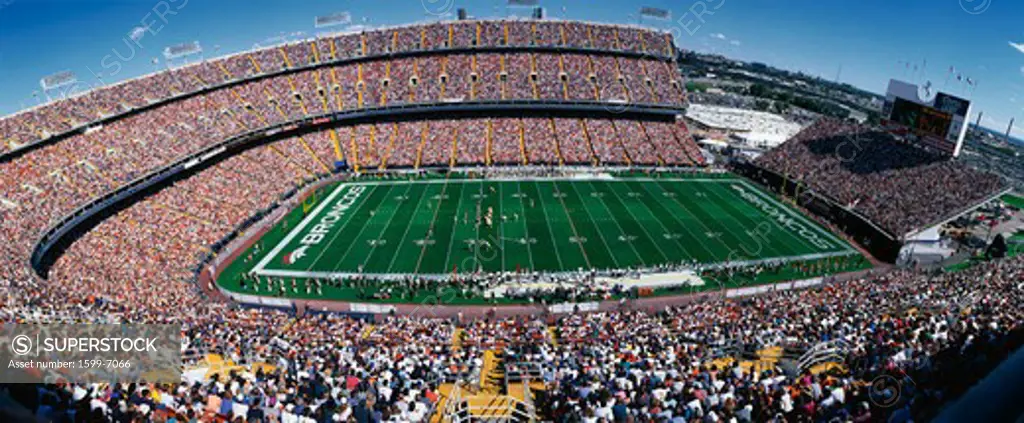 This is Mile High Stadium with the Denver Broncos playing the St. Louis Rams to a sold out crowd. This was an NFL game that took place on 9/14/97. The final score was Denver 35, St. Louis 14.