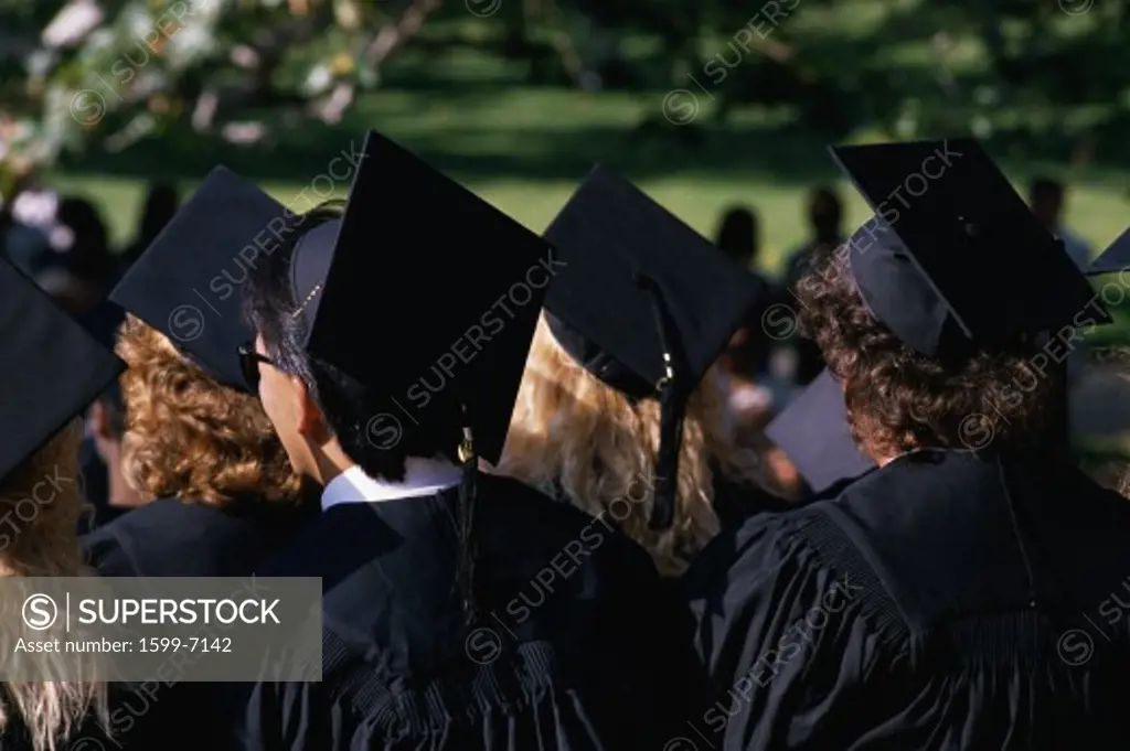 This is a college graduation ceremony at UCLA. They are in black caps and gowns. 