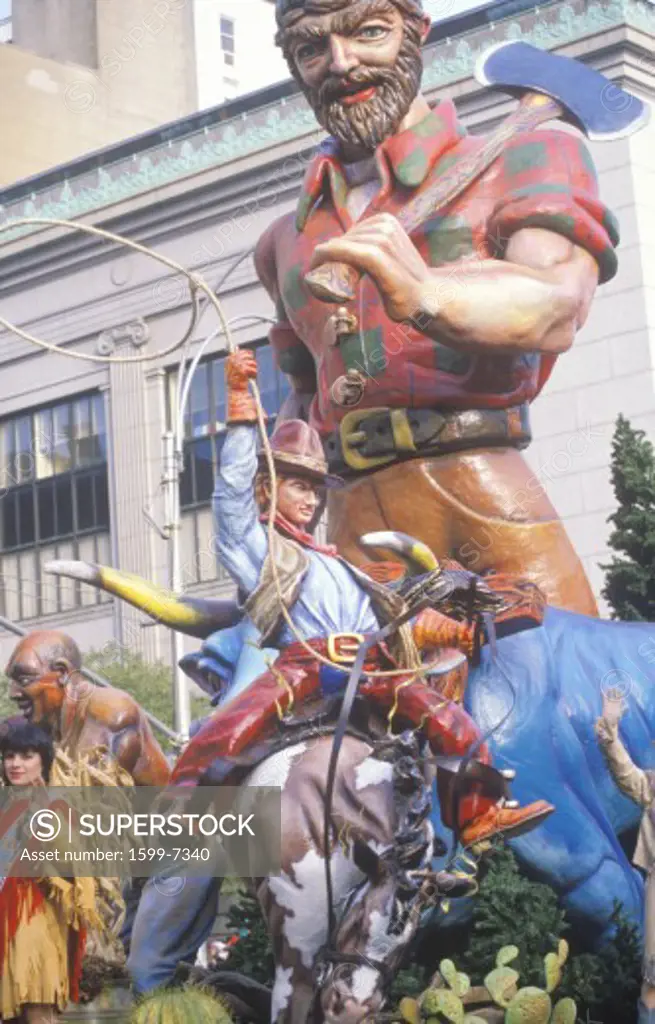 Parade float with Cowboy on bucking bronco and Paul Bunyan characters in Macy's Thanksgiving Day Parade, New York City, New York