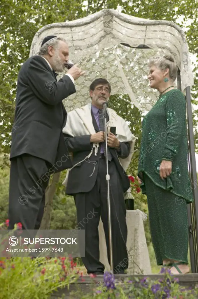 Wedding ceremony under a canopy with Rabbi, bride and groom at a traditional Jewish wedding in Ojai, CA