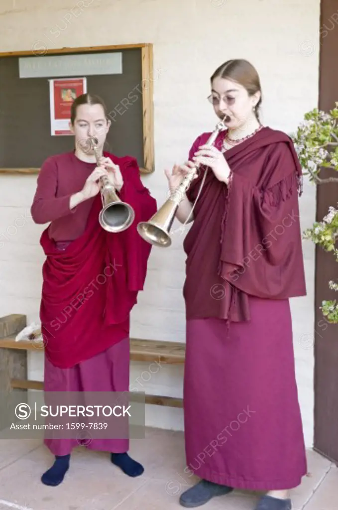 Two Buddhist nuns blow horns at Amitabha Empowerment Buddhist Ceremony, Meditation Mount in Ojai, CA