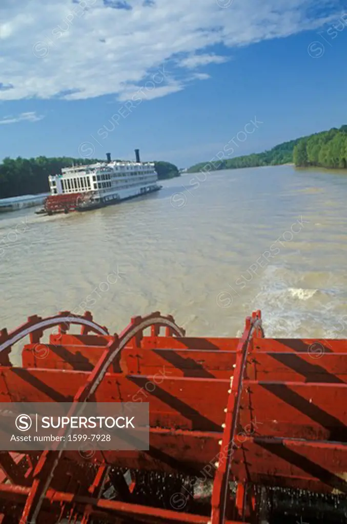 A second steamboat paddles down the Mississippi ahead of the Delta Queen's paddle wheel