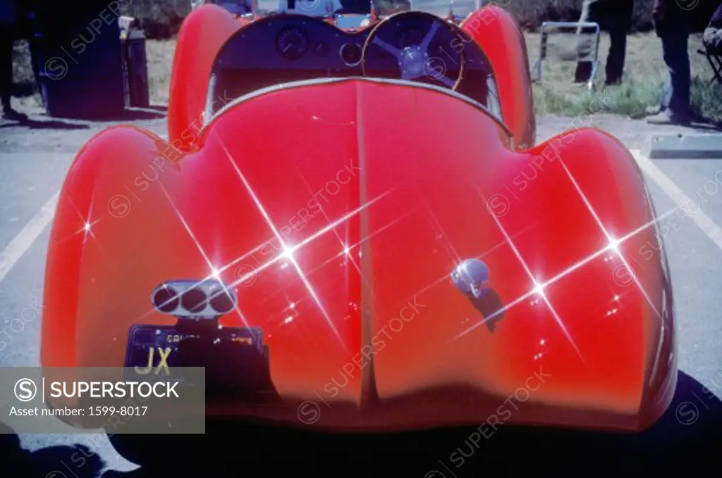 An Alfa Romeo Milano red car shown at the 35th Concours D' Elegance Show in Pebble Beach, Carmel, CA