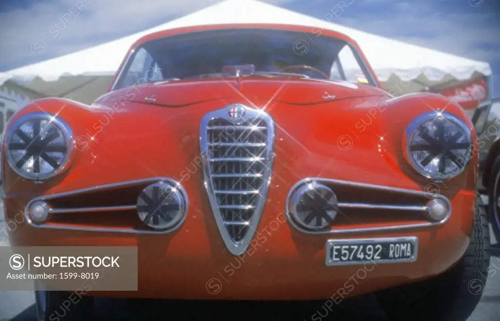 An Alfa Romeo Milano red car shown at the 35th Concours D' Elegance Show in Pebble Beach, Carmel, CA