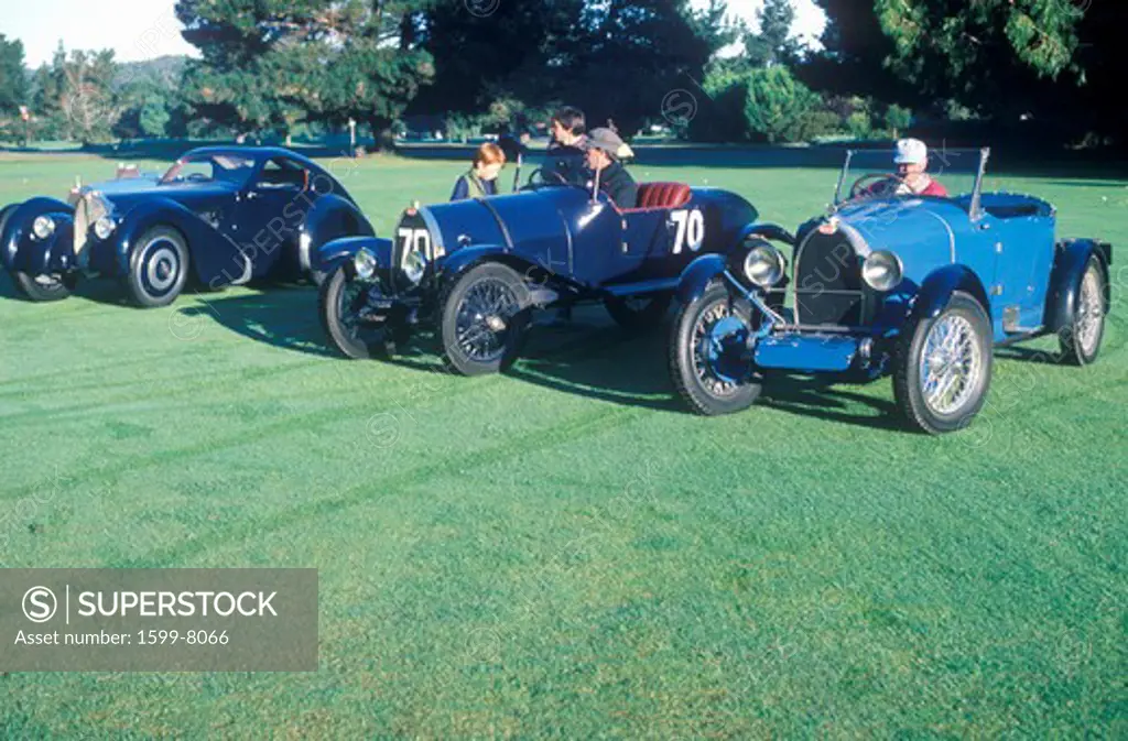 Three blue Bugatti cars at the 35th Annual Concours D' Elegance Competition in Carmel, CA