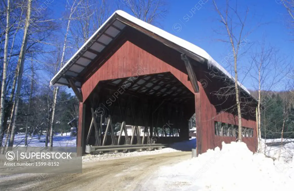 Covered bridge along Brook Road in Stowe, Vermont during the winter