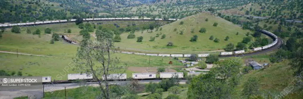 The Tehachapi Train Loop near Tehachapi California is the historic location of the Southern Pacific Railroad where freight trains gain 77 feet in elevation and show freight cars traveling in giant loop