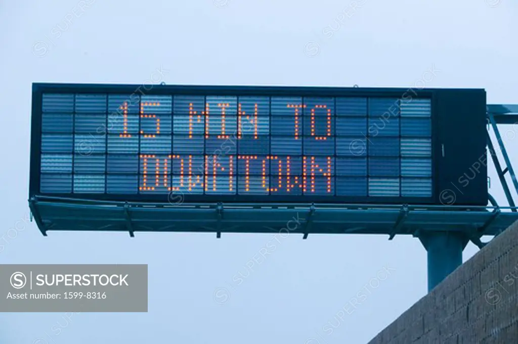 LED highway sign displays '15 minutes to downtown' showing how much traffic on Highway 101, Los Angeles, California