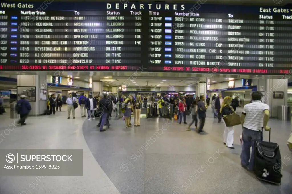 Amtrak train travelers stand in line under Departures sign at Penn Station, New York City, Manhattan, New York