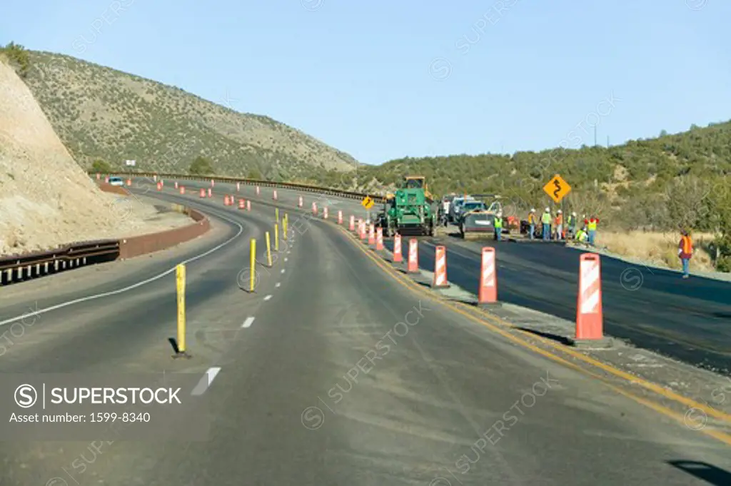 Highway workers work on state highway on Mescalero Apache Indian Reservation near Ruidoso and Alto, New Mexico