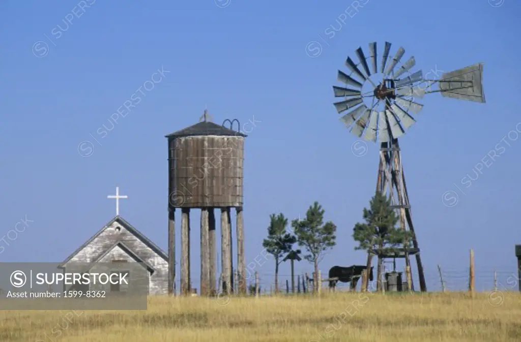 Windmill and abandoned prairie church, WY