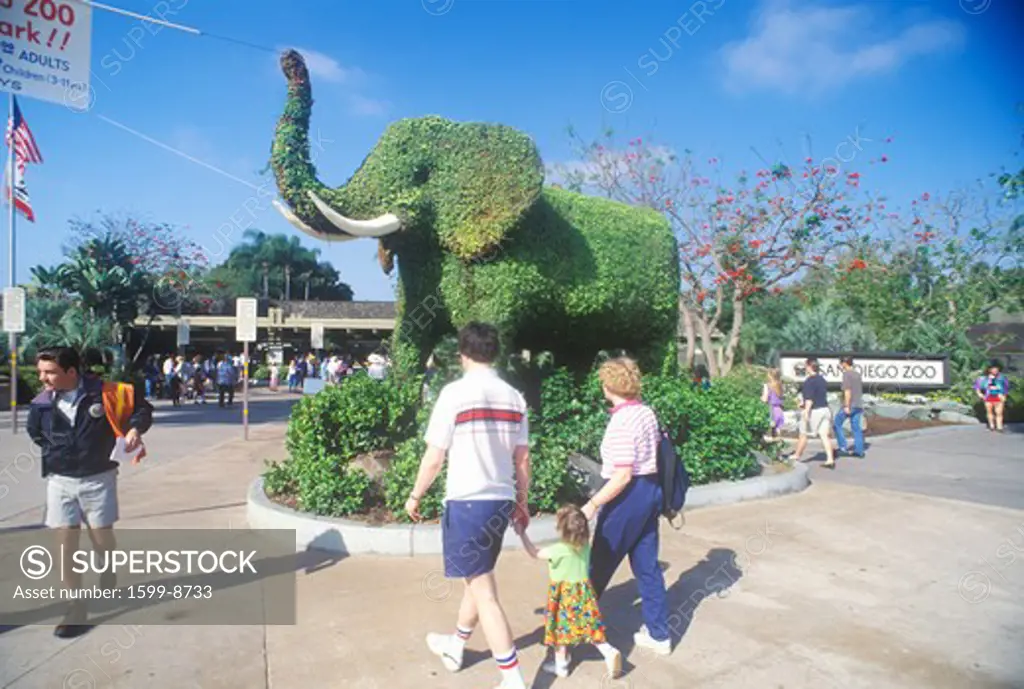 Tourists entering the San Diego Zoo, CA, with elephant topiary