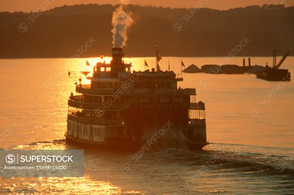 Rear view of The Delta Miss Queen steamboat on the Mississippi River at sunset