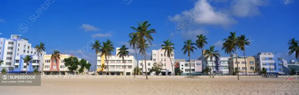 This is the art deco district of South Beach Miami. The buildings are painted in pastel colors surrounded by tropical palm trees.