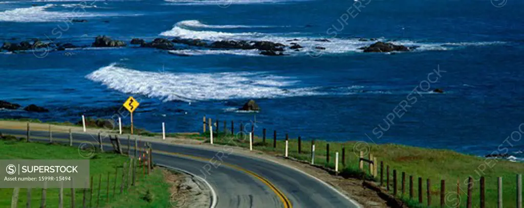 This is Route 1, also known as the Pacific Coast Highway. The ocean is to the right of the road which curves around a bend.