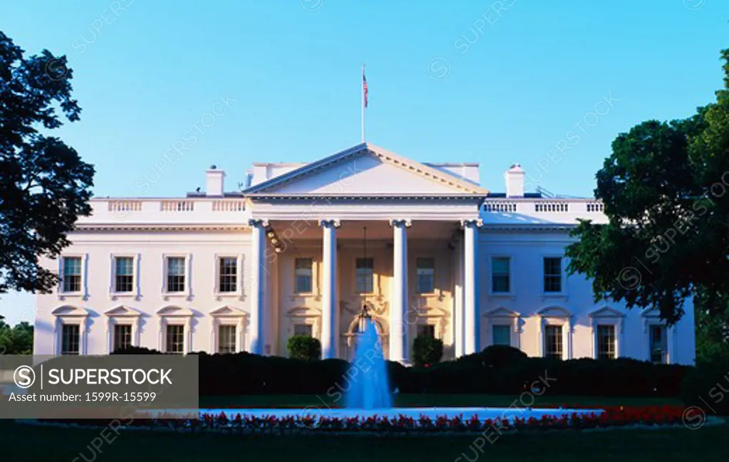 This is the White House in daylight. We see the fountain running in front. It is located on Pennsylvania Avenue. This is the home of the President of the United States.
