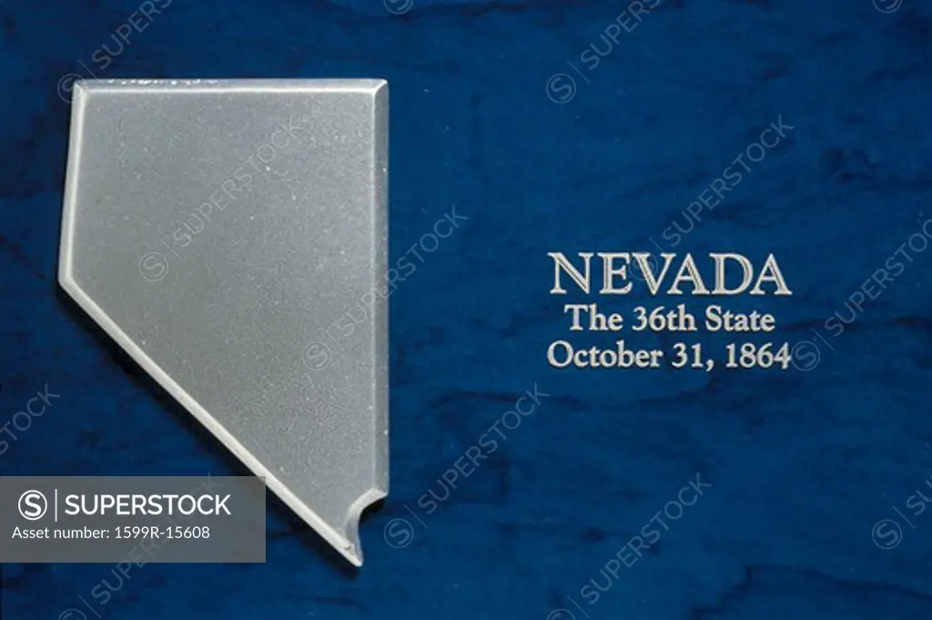 This is a silver map of the state of Nevada against a blue background. It says, Nevada, the 36th State, October 31, 1864 which is the date it entered the Union.