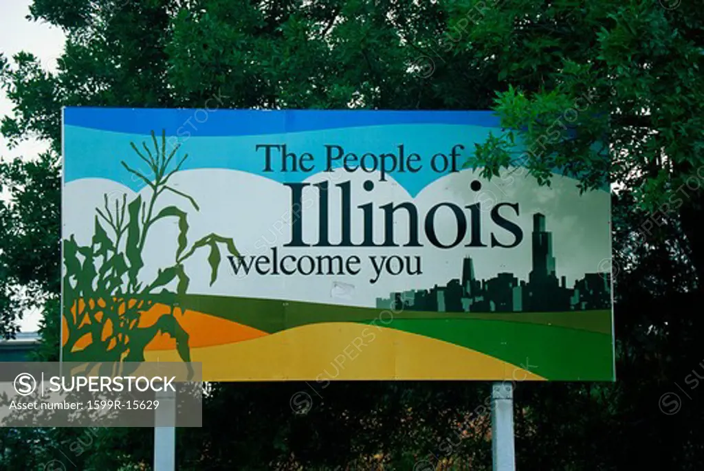 This is a road sign that says, the people of Illinois welcome you. There is a stalk of corn on one side of the sign, and the city skyline of Chicago on the other side. It is set near green trees.