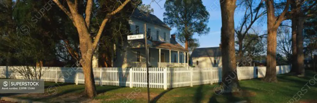 This is a photo of a typical suburban house on Main Street, USA. There is a white picket fence on a shaded, tree lined street with a green lawn. At the corner is a street sign that says, Main Street & Front Street. This is the Bonner House which was built in 1820. The town of Bath was founded in 1690.