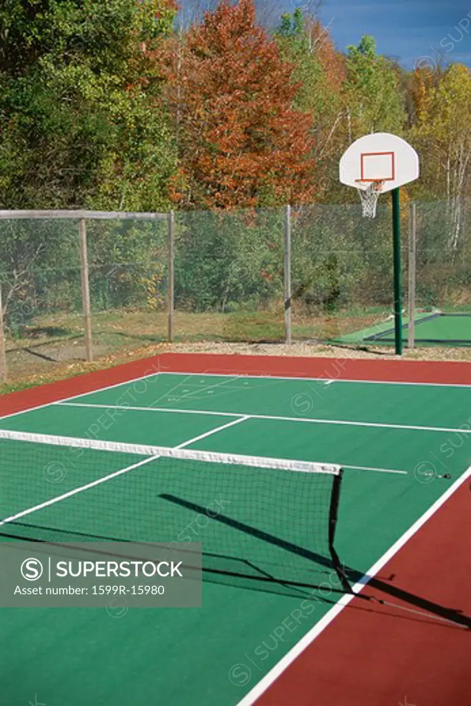 Tennis court with basketball hoop