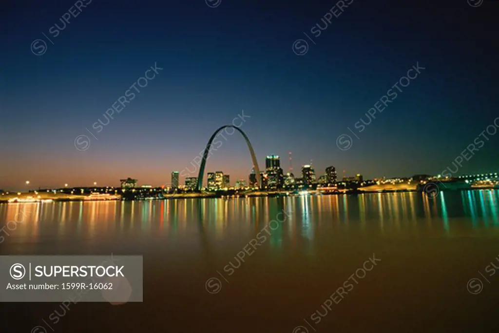 St. Louis at night, reflecting on water
