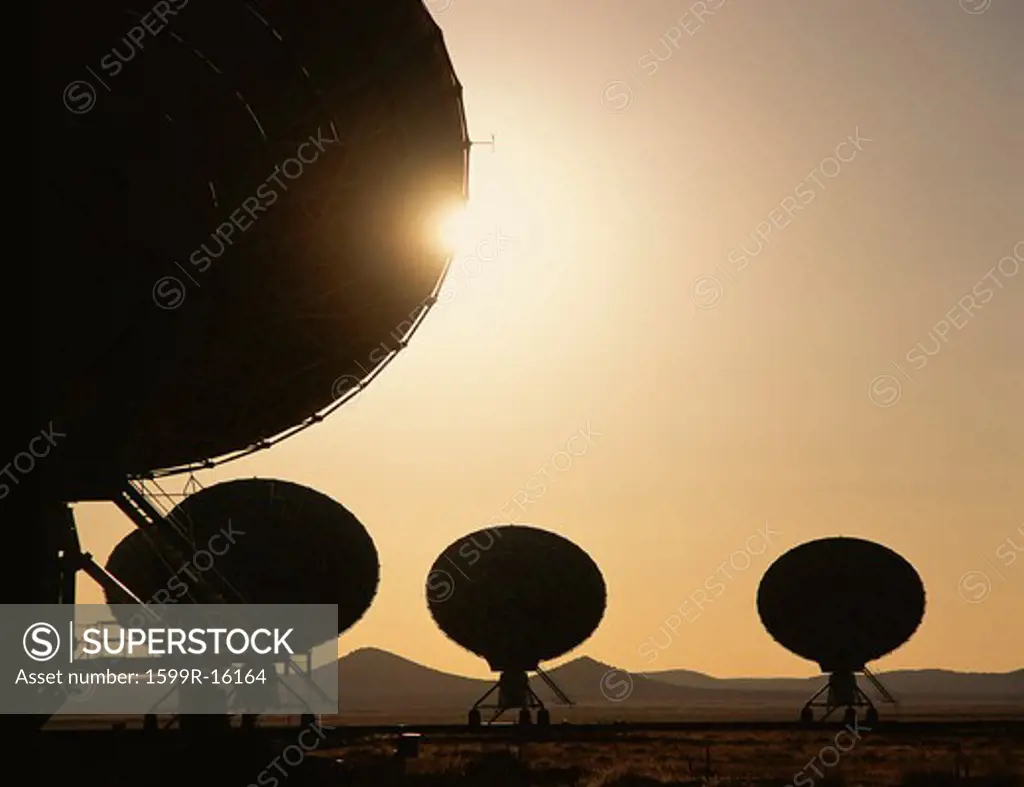 Silhouetted VLA Very Large Array radio telescope dishes