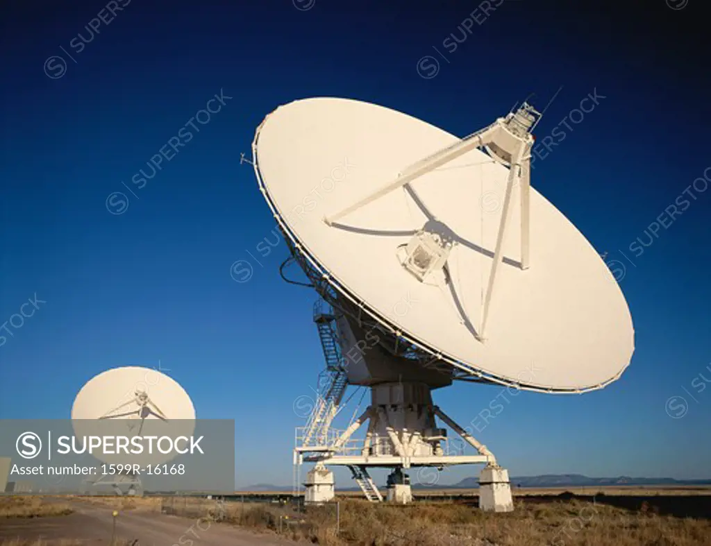Two VLA Very Large Array radio telescope dishes facing up