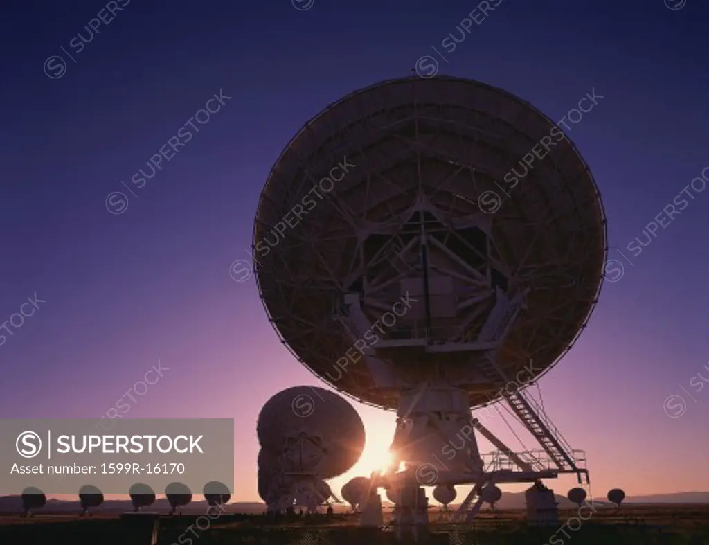 Silhouetted field of VLA Very Large Array radio telescope dishes