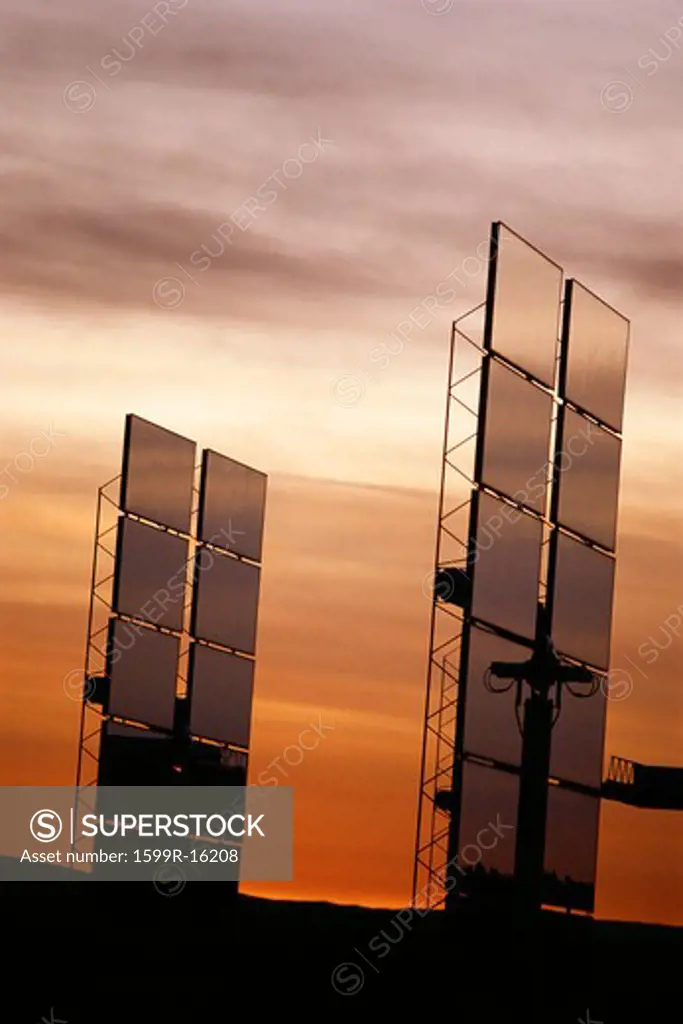 Upright solar panels against sunset