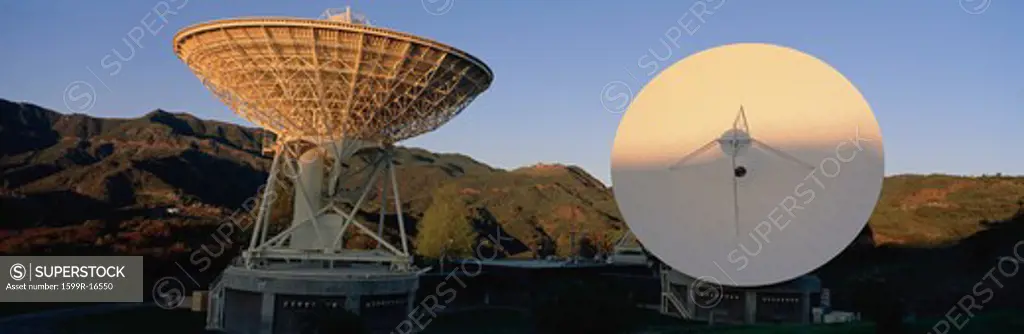 Two array/satellite dishes partially lit
